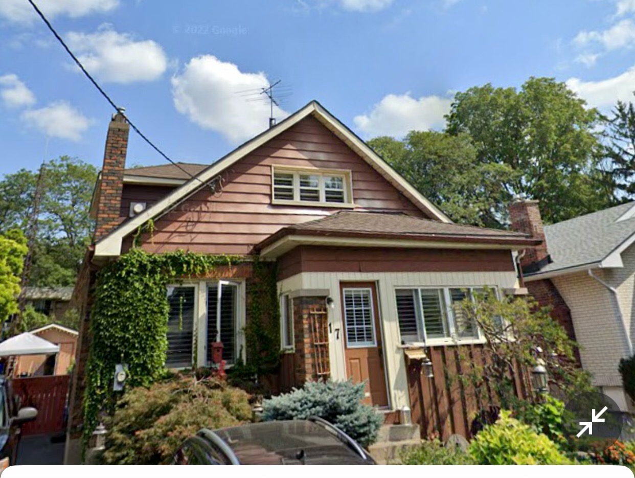 Older home with dated brown wood siding before an exterior renovation